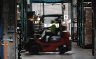 red forklift driver operating in warehouse